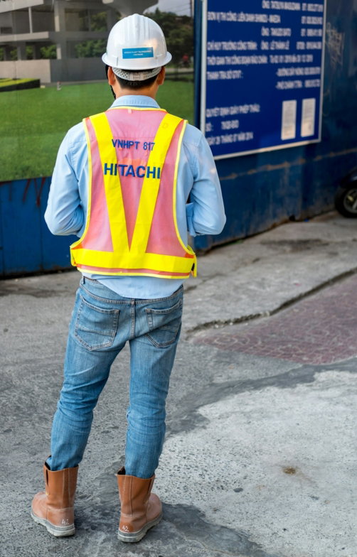 man-standing-near-blue-wooden-sign.jpg man standing near blue wooden sign
